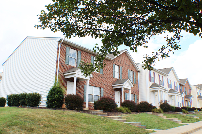 A set of brick townhouses in a row of townhomes